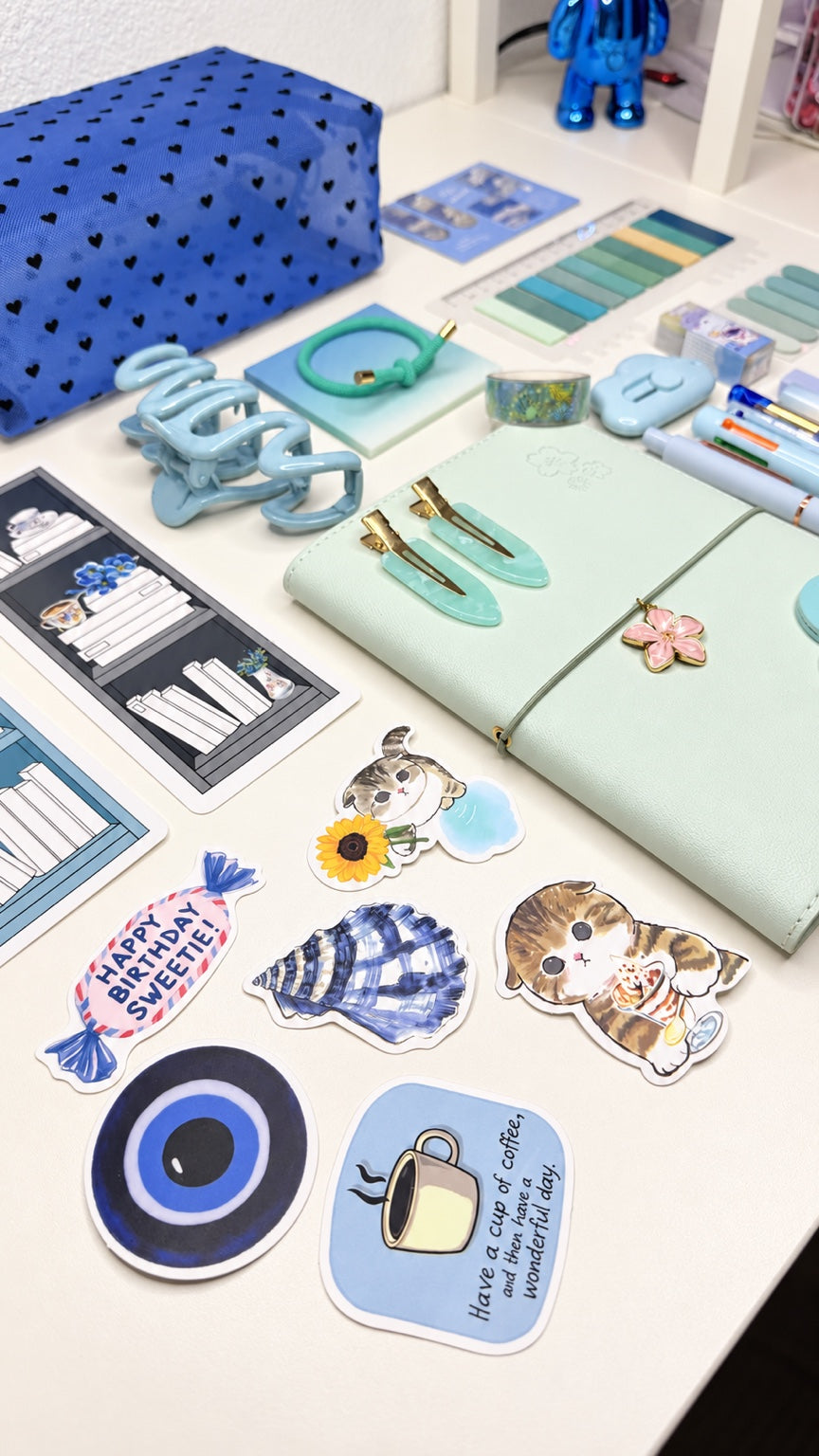 Blue stationery set with notebook, stickers, pouch, pens, and accessories