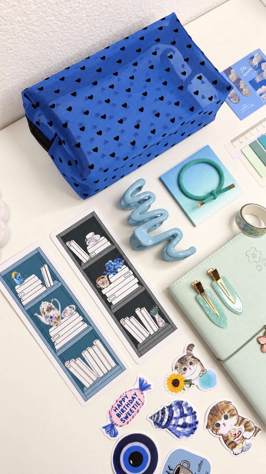 Blue stationery gift set arranged with notebook, bookmarks, pouch, and stickers