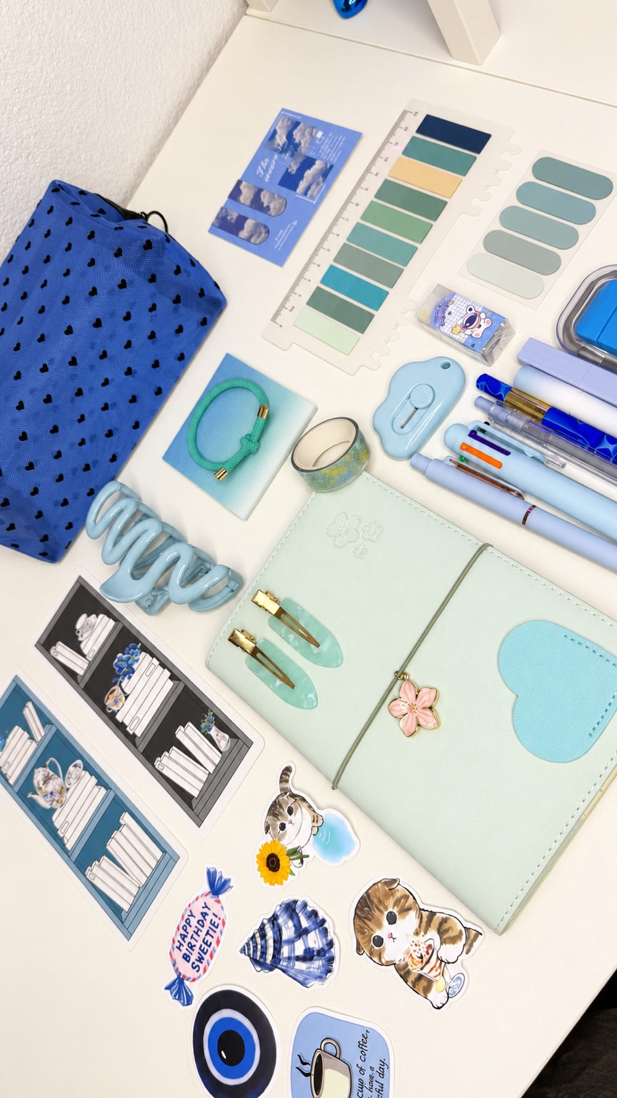Complete blue stationery set with matching notebook, pens, pouch, stickers, and desk accessories