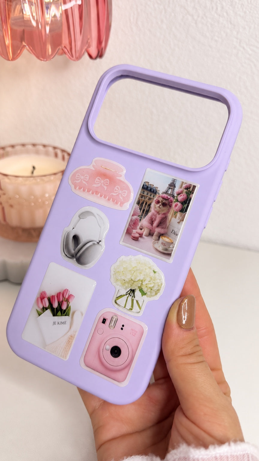 Purple silicone iPhone 17 Pro Max sticker case held at an angle